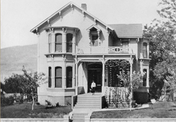 Person standing on front porch, circa 1900